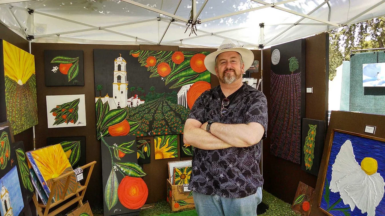 Guy Wann Standing infront of "Parade of Oranges"